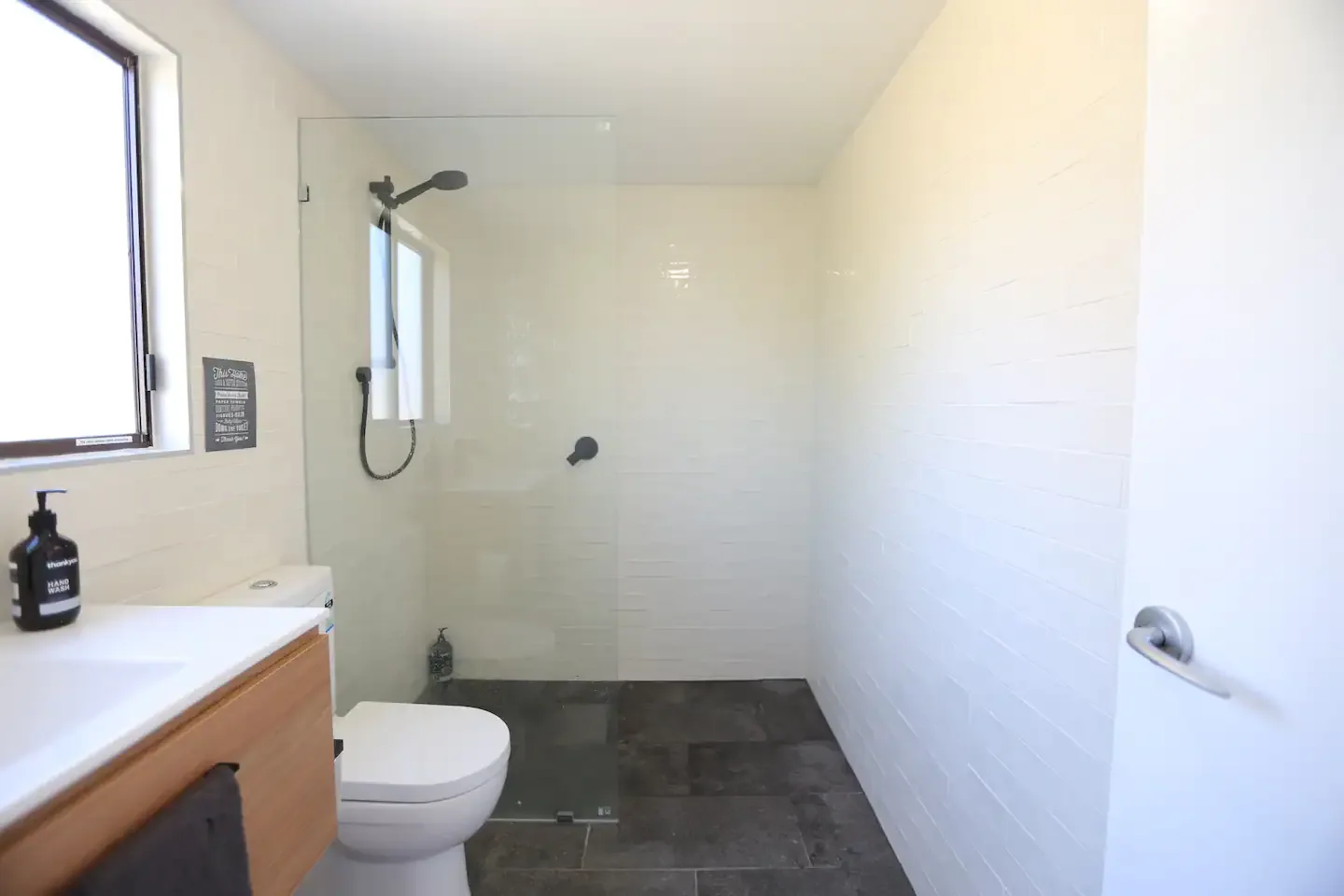 Walk-in shower with frameless glass screen