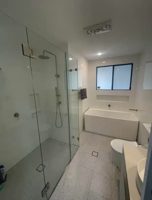 Narrow bathroom with glass shower screen