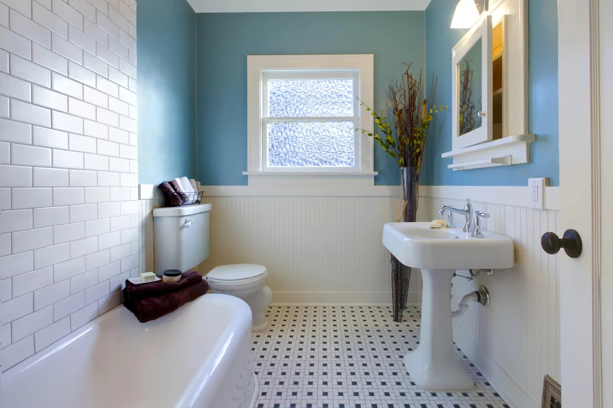 Classic bathroom with pedestal basin and blue walls