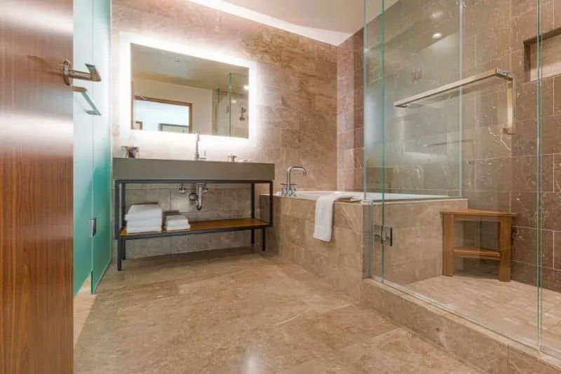 Bathroom with travertine tiles and glass shower