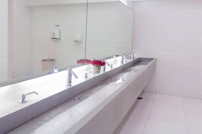 Commercial washroom with long trough basin